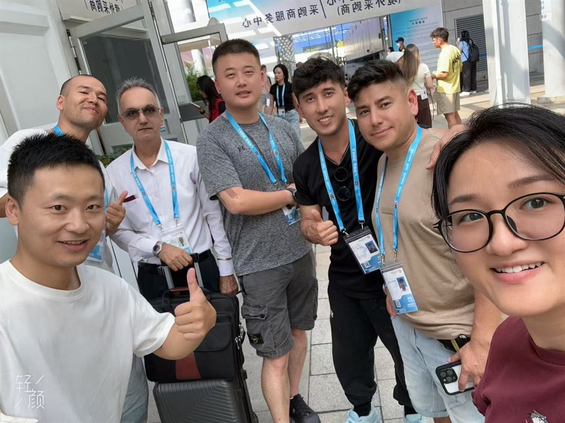 AIKU team with a buyer group at a trade fair entrance